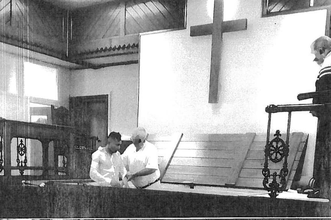 Abdul Ezedi, left, being baptised