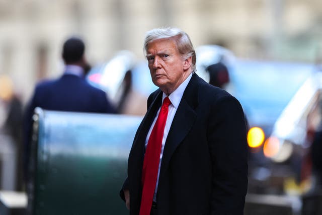 <p>Former US President Donald Trump arrives at 40 Wall Street after his court hearing to determine the date of his trial for allegedly covering up hush money payments linked to extramarital affairs in New York City on March 25, 2024</p>