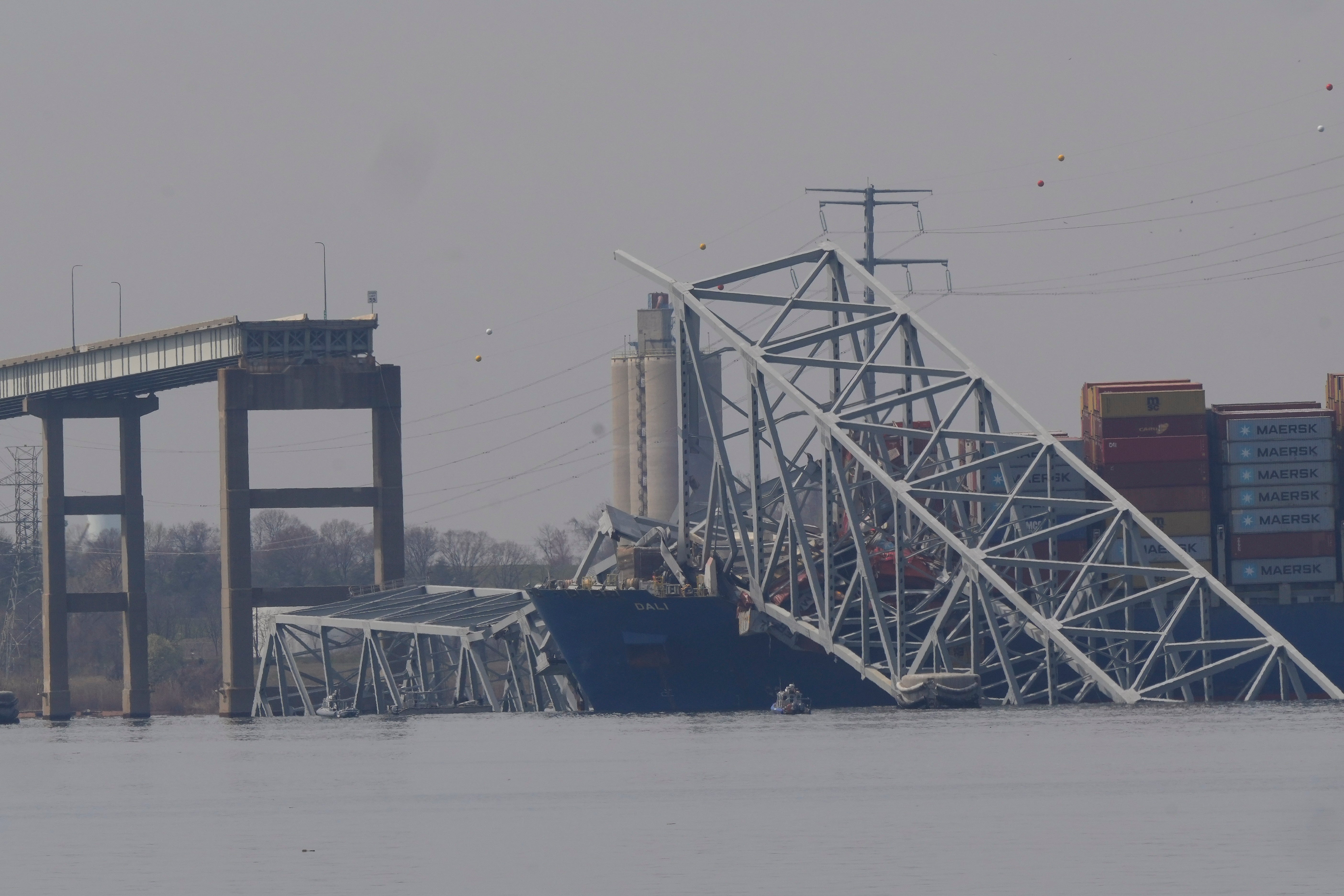The container ship Dali rests against wreckage of the Francis Scott Key Bridge