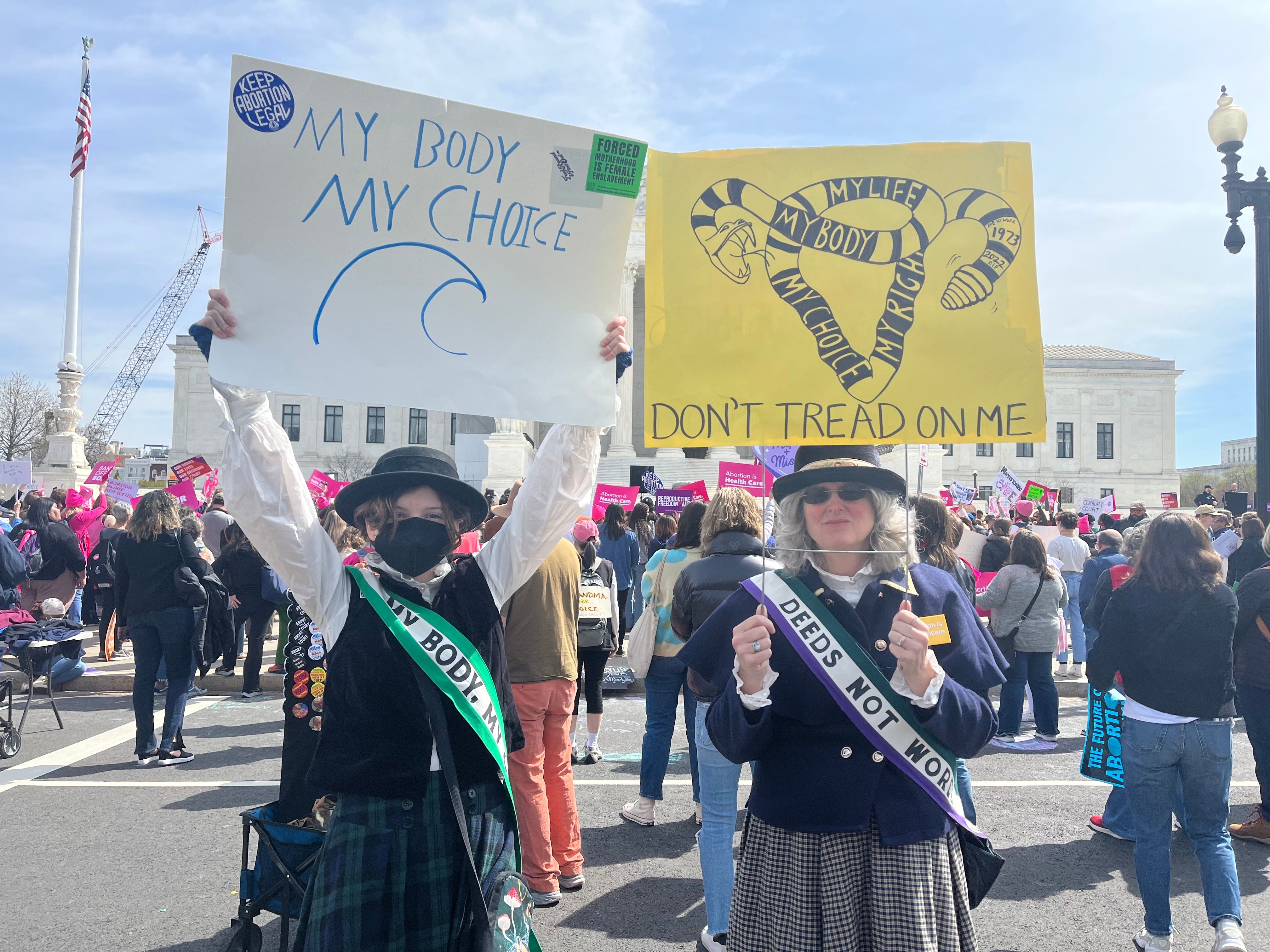 Darcy Nair, right, participates in an abortion rights demonstration dressed as a suffragette