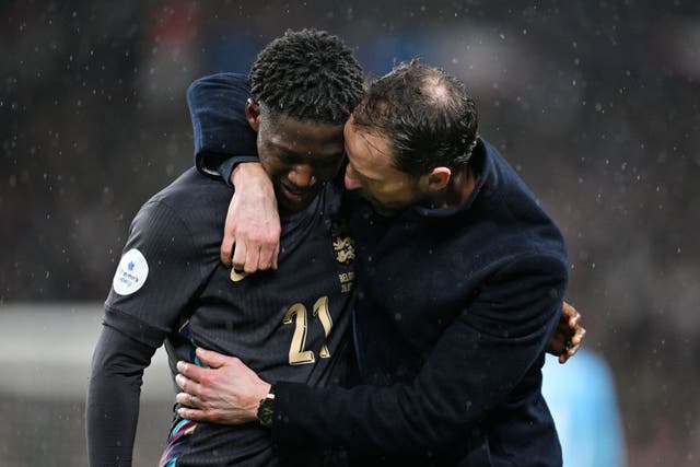 <p>Kobbie Mainoo is greeted by Gareth Southgate after his impressive England debut </p>