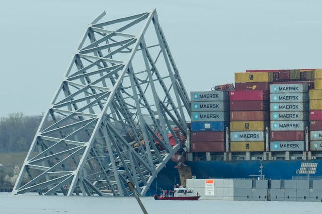 <p>A container ship as it rests against wreckage of the Francis Scott Key Bridge on Tuesday, 26 March 2024</p>