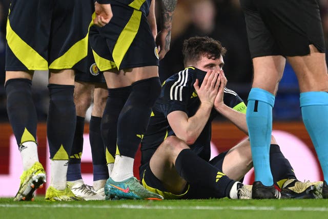 <p>Scotland captain Andy Robertson reacts after picking up an ankle injury </p>