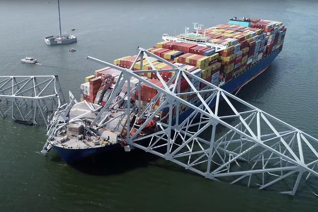 <p>Part of the steel frame of the Francis Scott Key Bridge sitting on top of the container ship Dali after the bridge collapsed in Baltimore</p>