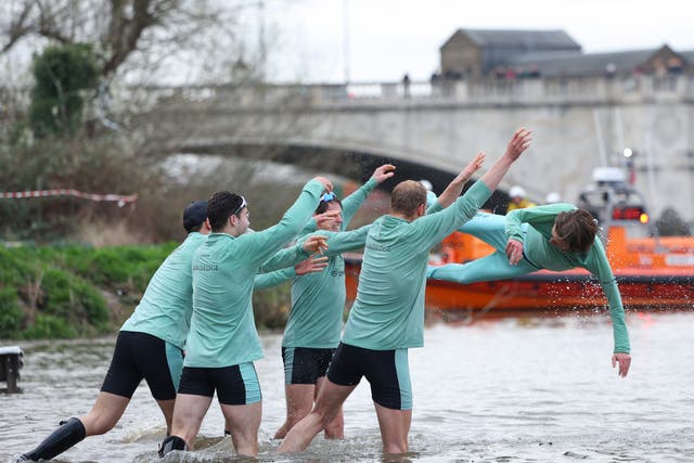 <p>Cox Jasper Parish of Cambridge University Boat Club is thrown into the Thames by teammates</p>