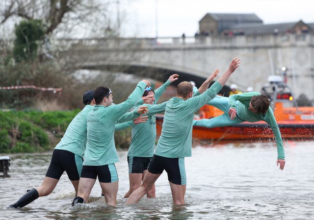 <p>Cox Jasper Parish of Cambridge University Boat Club is thrown into the Thames by teammates</p>