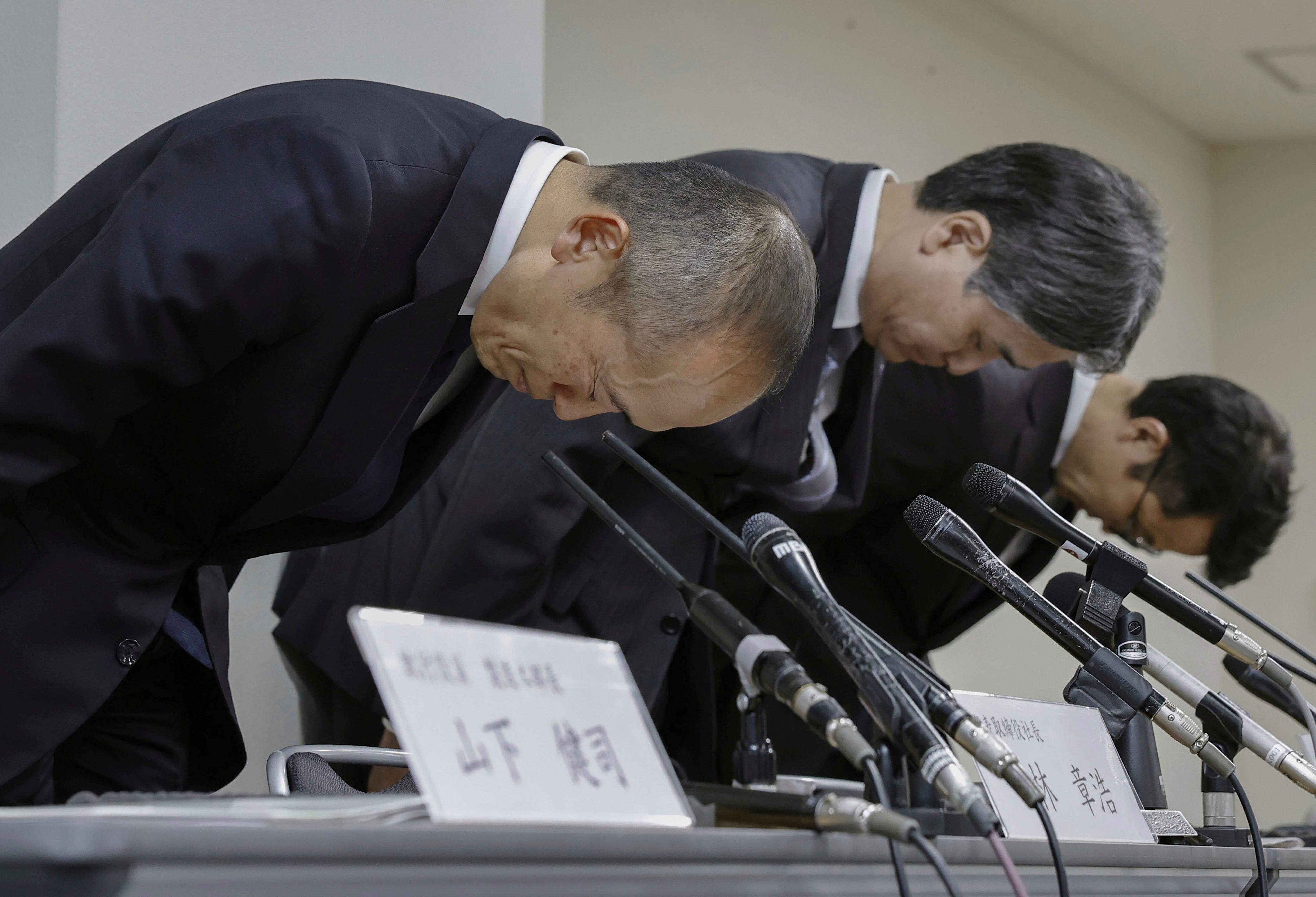 Akihiro Kobayashi, President of Kobayashi Pharmaceutical Co., left, bows during a press conference in Osaka, on March 22