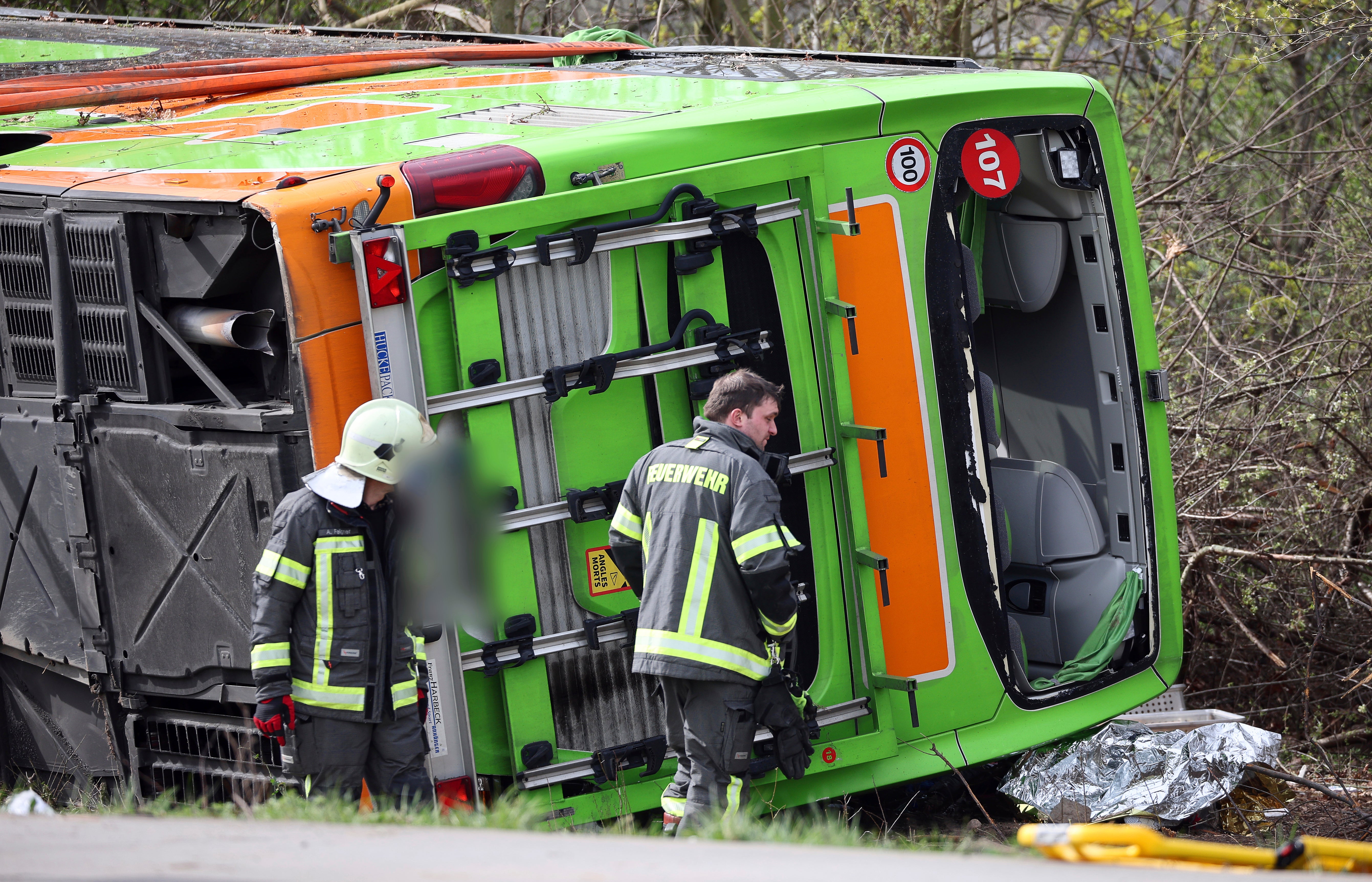 A coach lies overturned on its side at the scene of an accident on the A9, near Schkeuditz, Germany