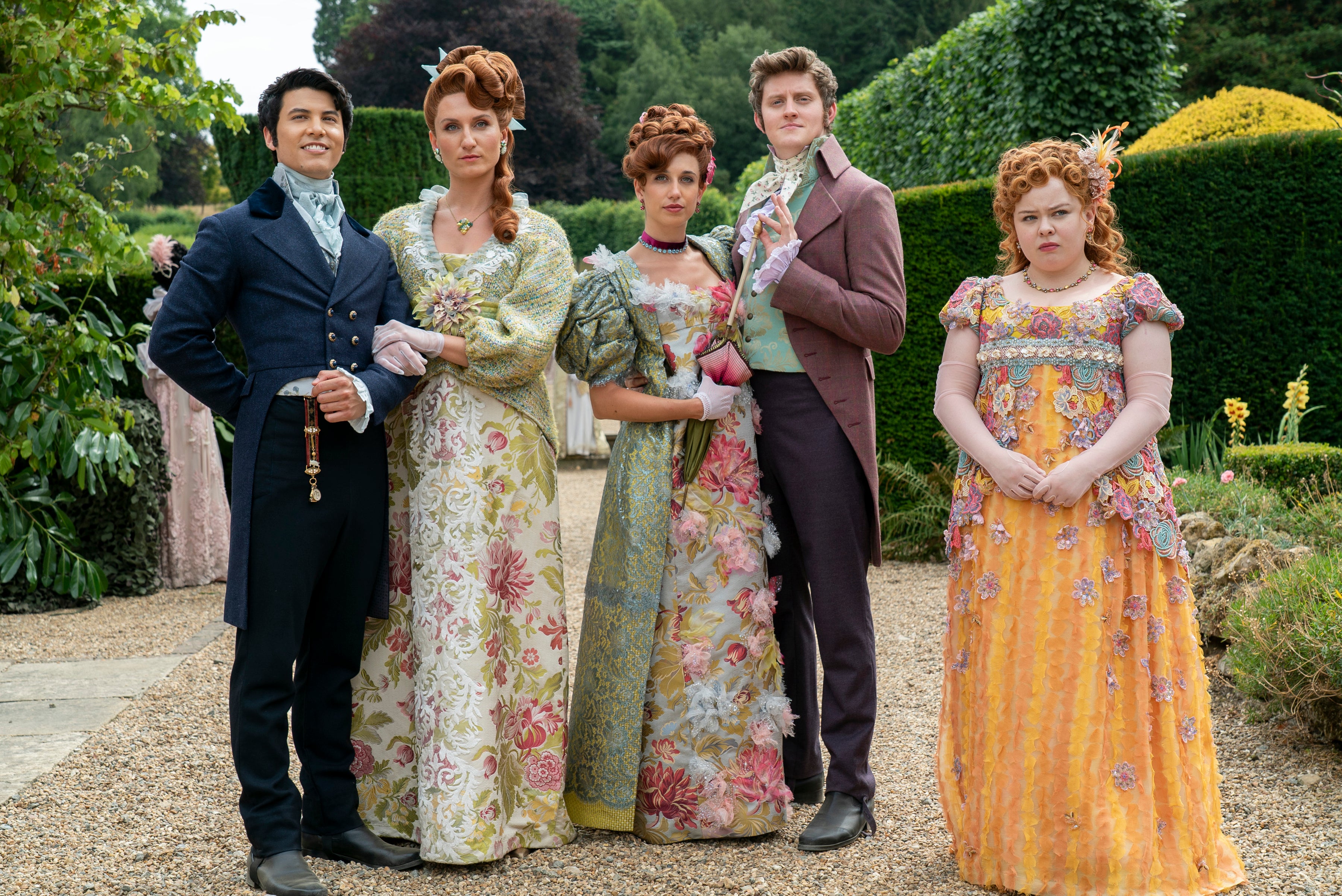 The cast of Bridgerton dressed in Regency era-inspired costumes in season three
