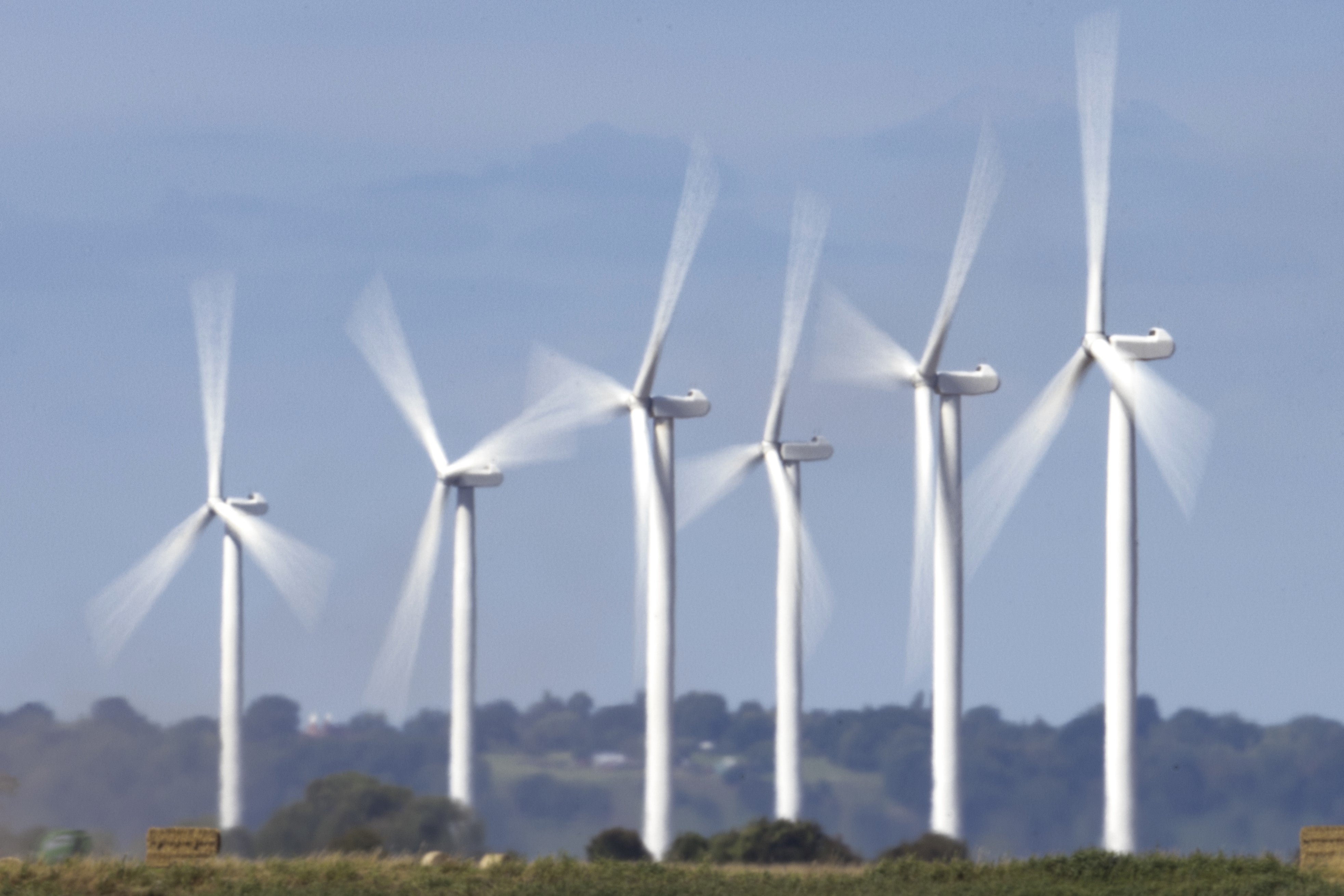 Wind turbines and power lines in Camber, United Kingdom, on 10 August, 2023