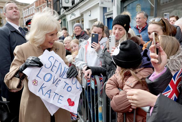 <p>As the Queen did her walkabout, two young girls handed her posters decorated with stars and hearts with a message: ‘Send love to Kate’ </p>