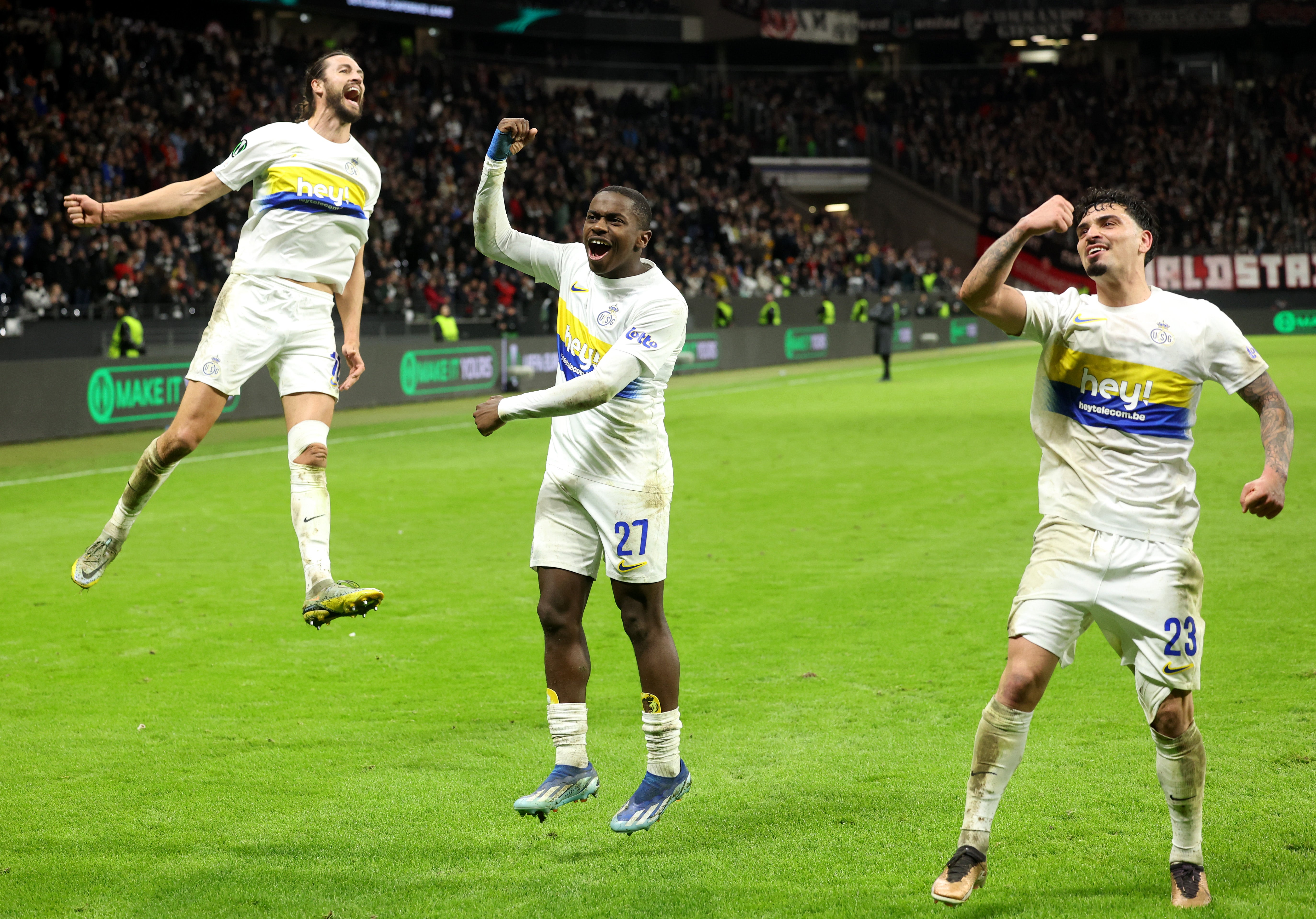 Christian Burgess, Noah Sadiki and Cameron Puertas of Union Saint-Gilloise celebrate victory in the Uefa Europa Conference League playoffs
