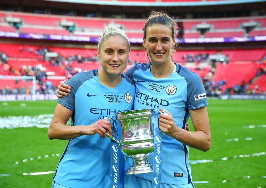 Houghton holds the FA Cup trophy with former Man City and England teammate Jill Scott