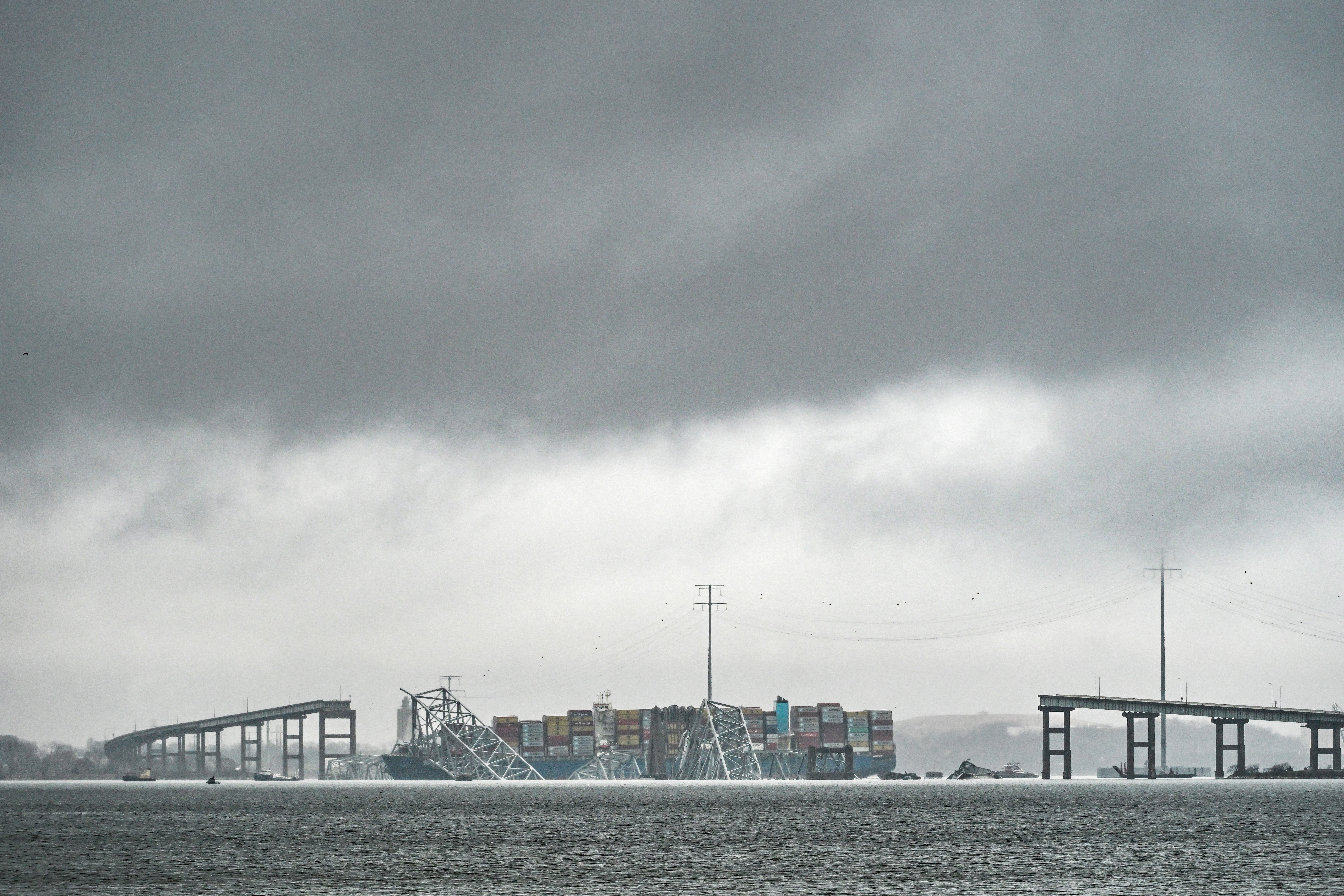 <p>The Dali, a Singaporean-flagged cargo vessel that spans the size of almost three football fields, remains stuck under debris from the Francis Scott Key Bridge</p>