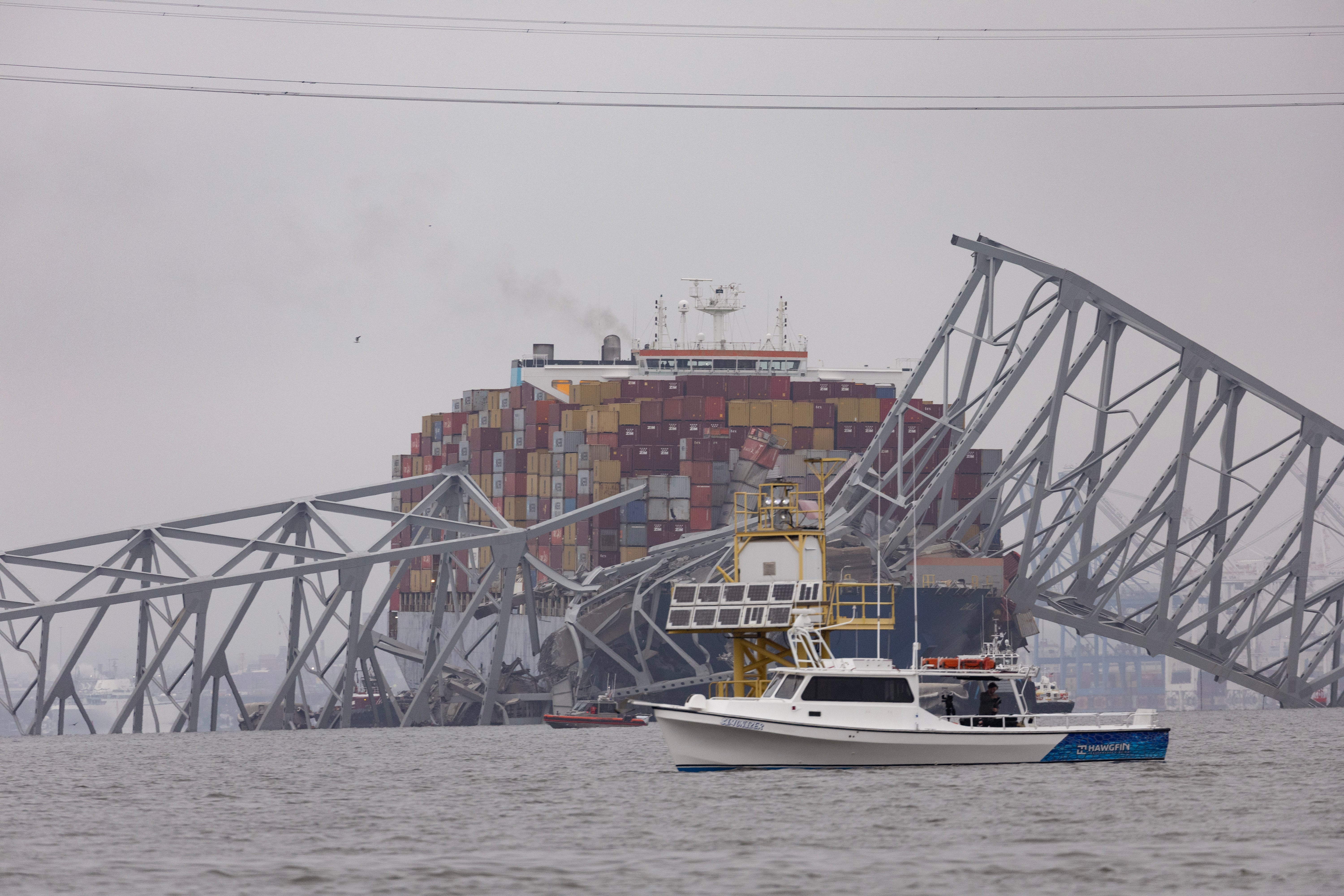 <p>Workers continue to investigate and search for victims after the cargo ship Dali collided with the Francis Scott Key Bridge</p>