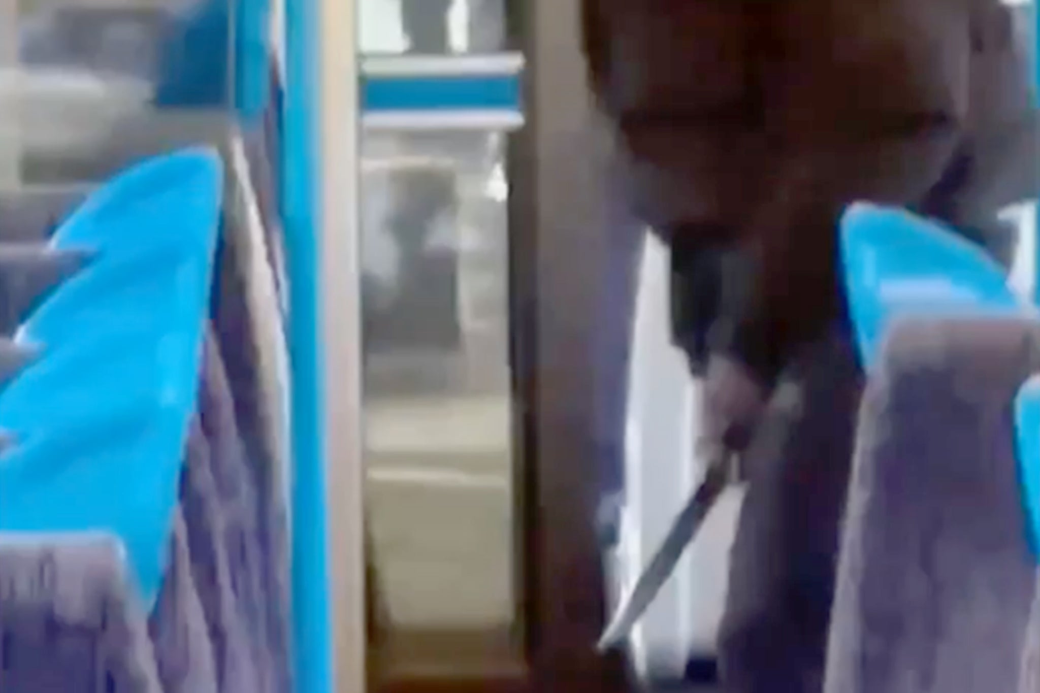 The shocking video shows a man in a puffer-style jacket and a mask attacking his victim