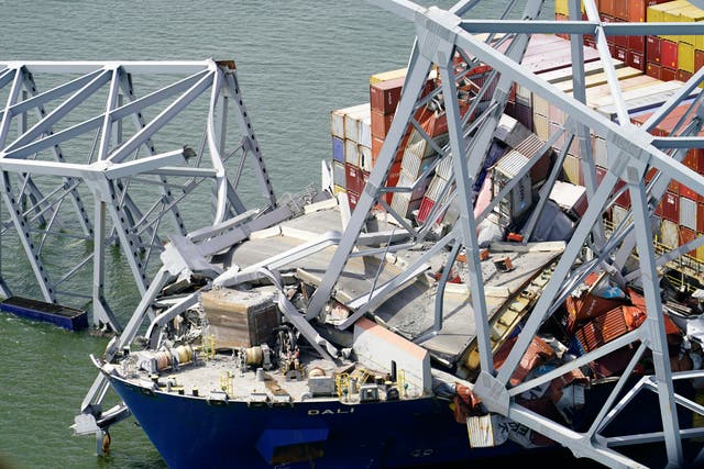 <p>In this aerial image released by the Maryland National Guard, the cargo ship Dali is stuck under part of the structure </p>