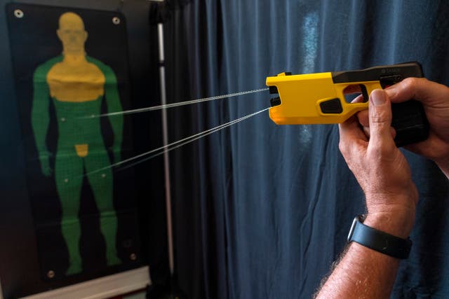 <p>A representative for Axon Enterprise Inc. demonstrates the company's TASER 7 in Washington on Thursday, May 12, 2022. </p>