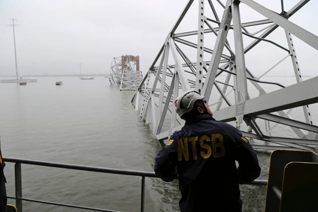 <p>In this image released by the National Transportation and Safety Board, a NTSB investigator is seen on the cargo vessel Dali, which struck and collapsed the Francis Scott Key Bridge on 27 March </p>