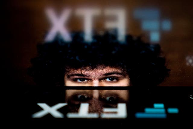 <p>The logo of cryptocurrency FTX, reflected in an image of former chief executive Samuel Bankman-Fried, in Washington, DC, on November 13, 2022</p>