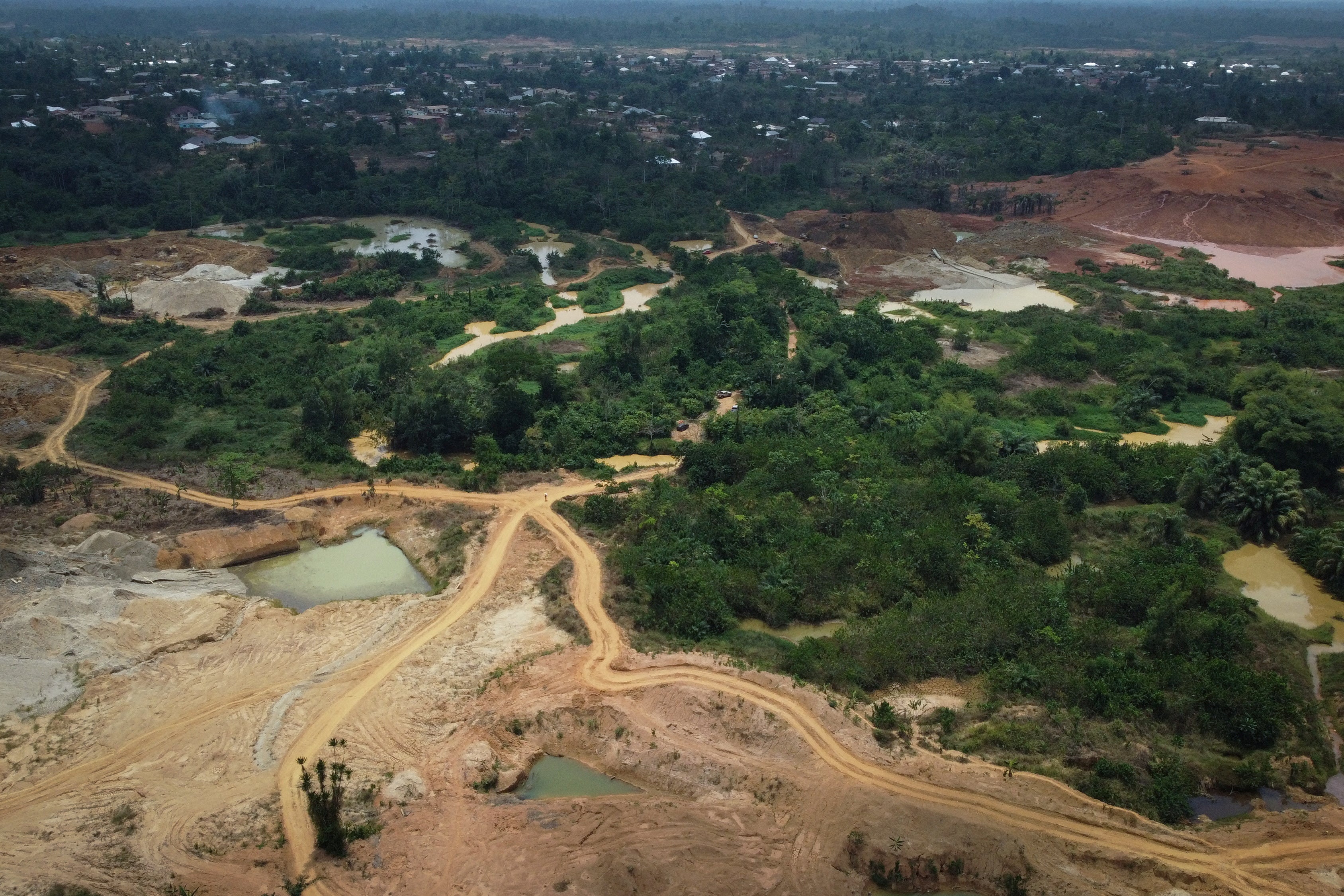 A drone view shows cocoa plantations and farms destroyed by illegal gold mining in Kwabeng