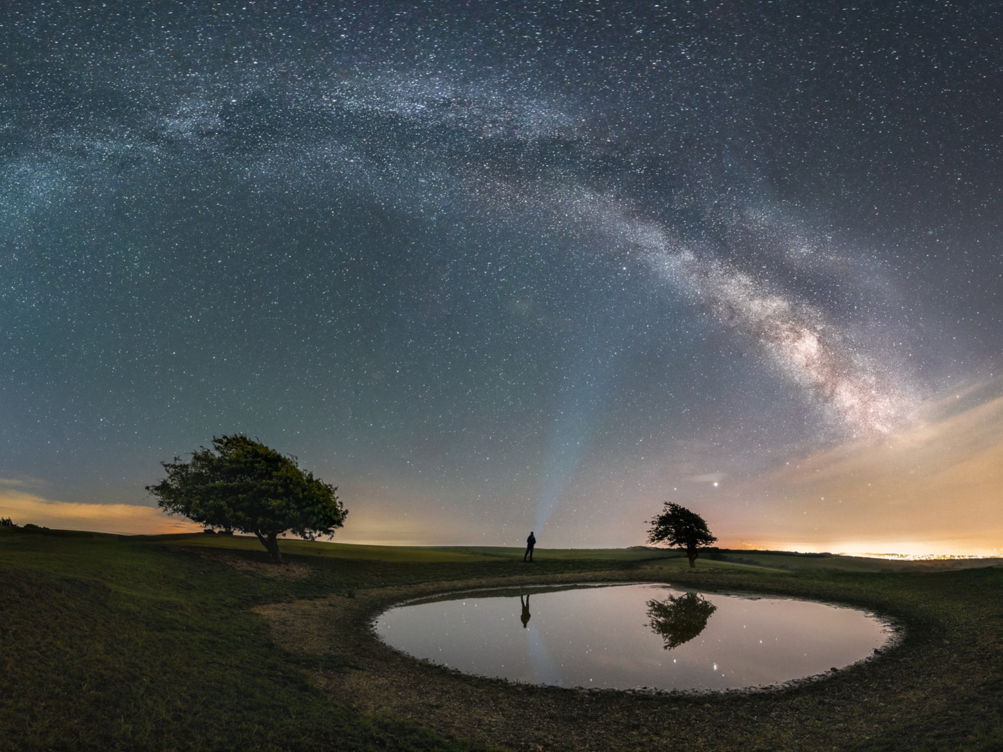 Panoramic photo of the Milky Way over the dew pond at Ditchling Beacon
