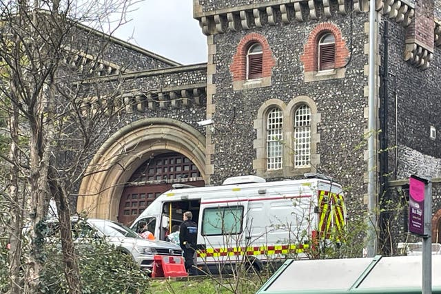 <p>Emergency personnel outside HMP Lewes after several prisoners are believed to have become unwell after getting food poisoning  </p>