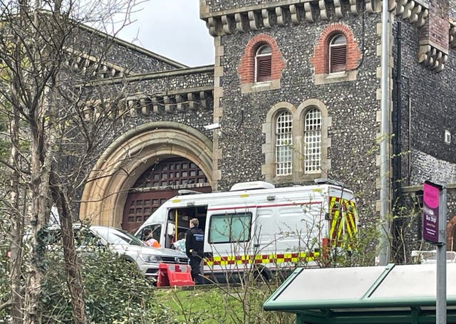 <p>Emergency personnel outside HMP Lewes after several prisoners are believed to have become unwell after getting food poisoning  </p>