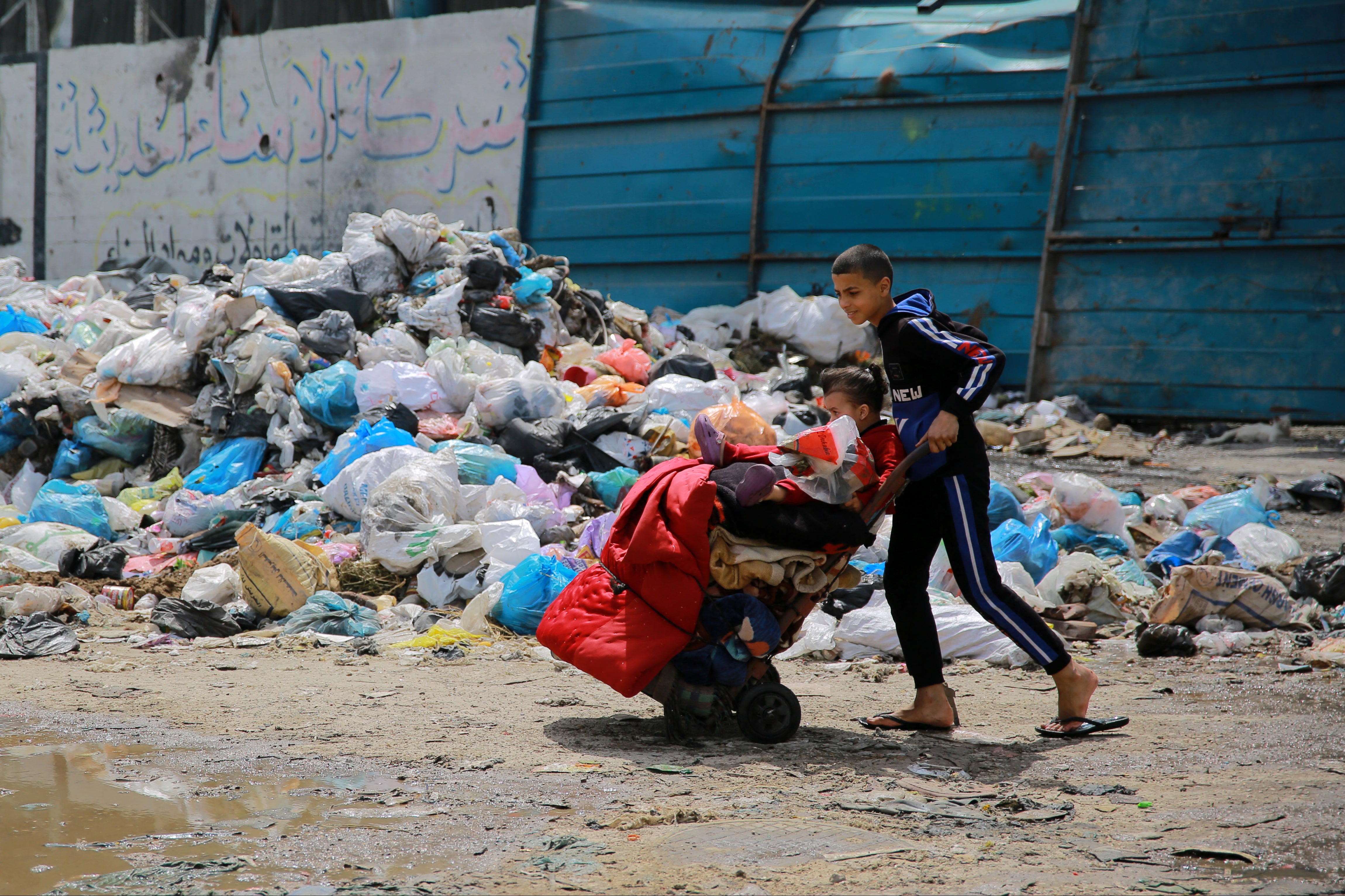 A child walks through Gaza City with belongings