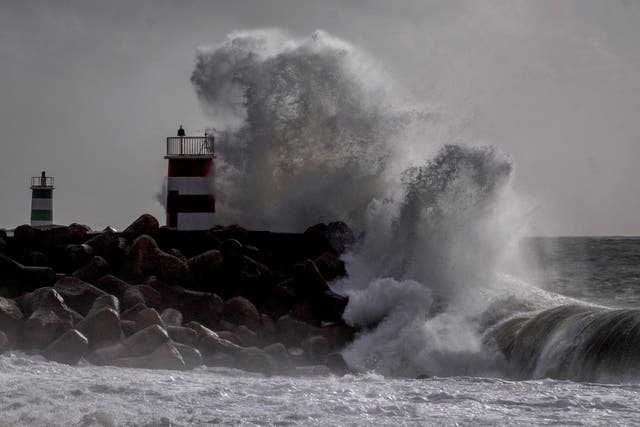 <p>Big waves crash against a light house in Nazare, Portugal, Wednesday, March 27, 2024</p>