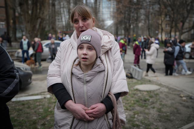 <p>Residents of the Pechersk district stand near an area damaged by a Russian air attack in Kyiv, Ukraine, on Monday</p>