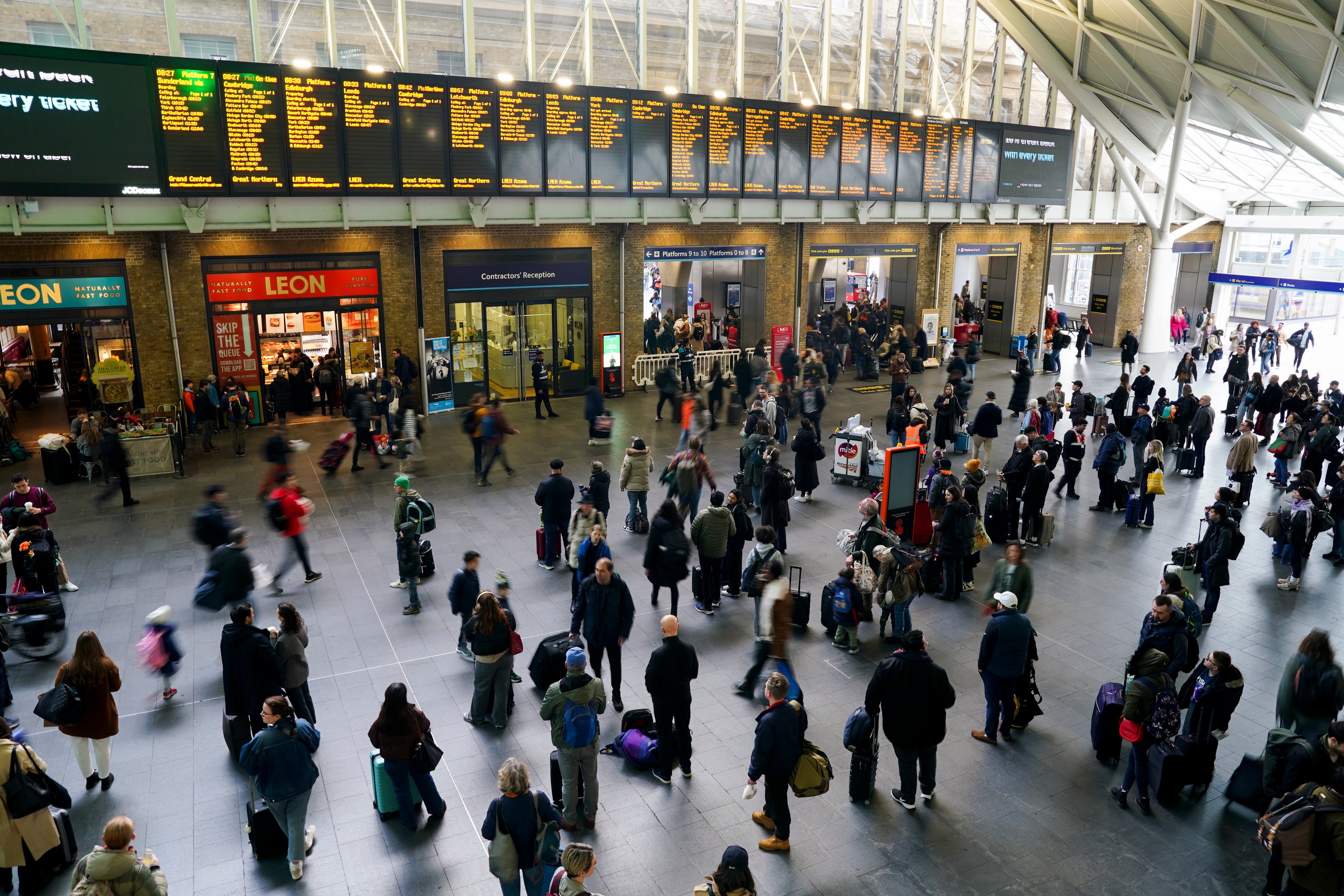 Passengers waiting for trains at London King's Cross Station on Good Friday