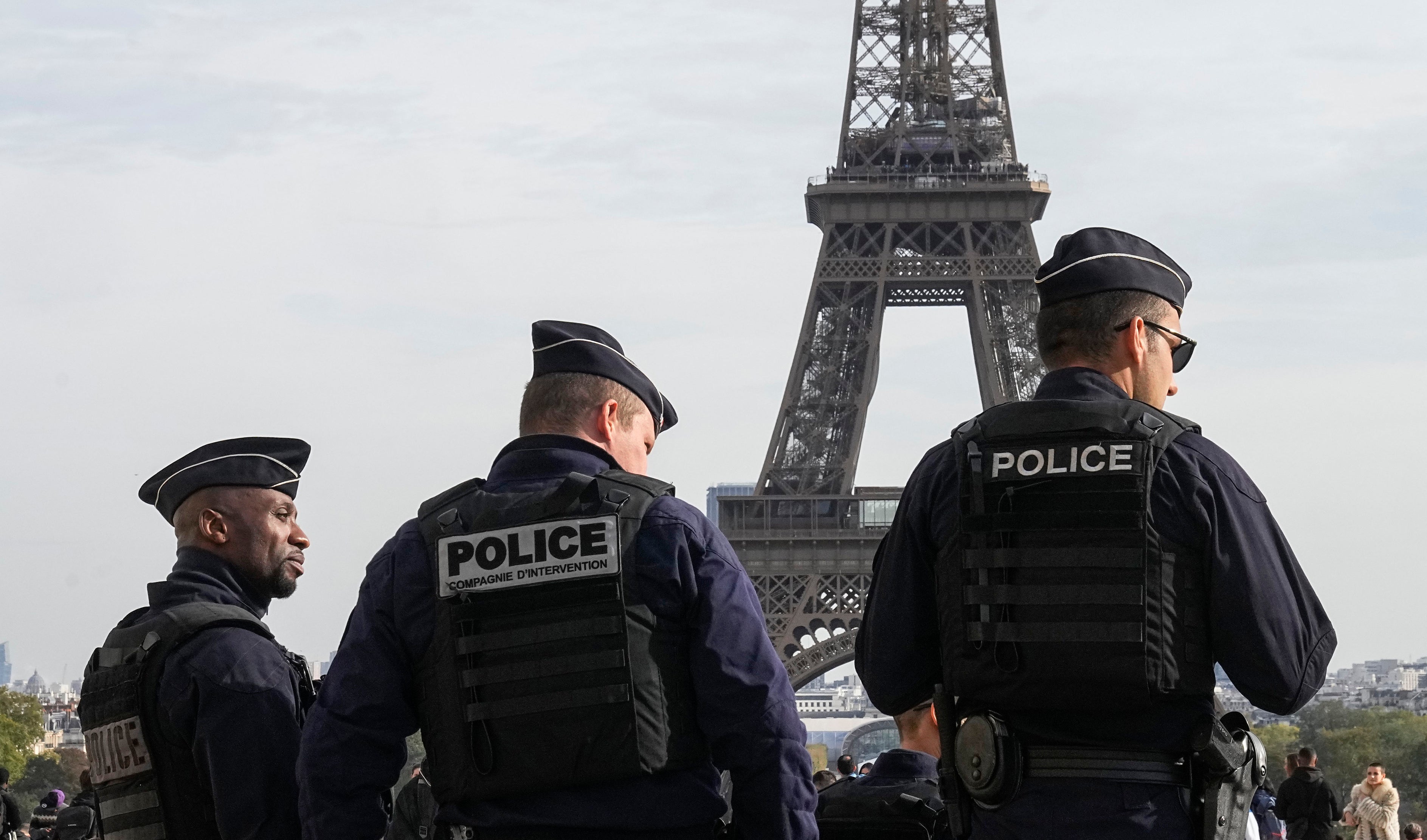 Police officers patrol the Trocadero plaza near the Eiffel Tower in Paris