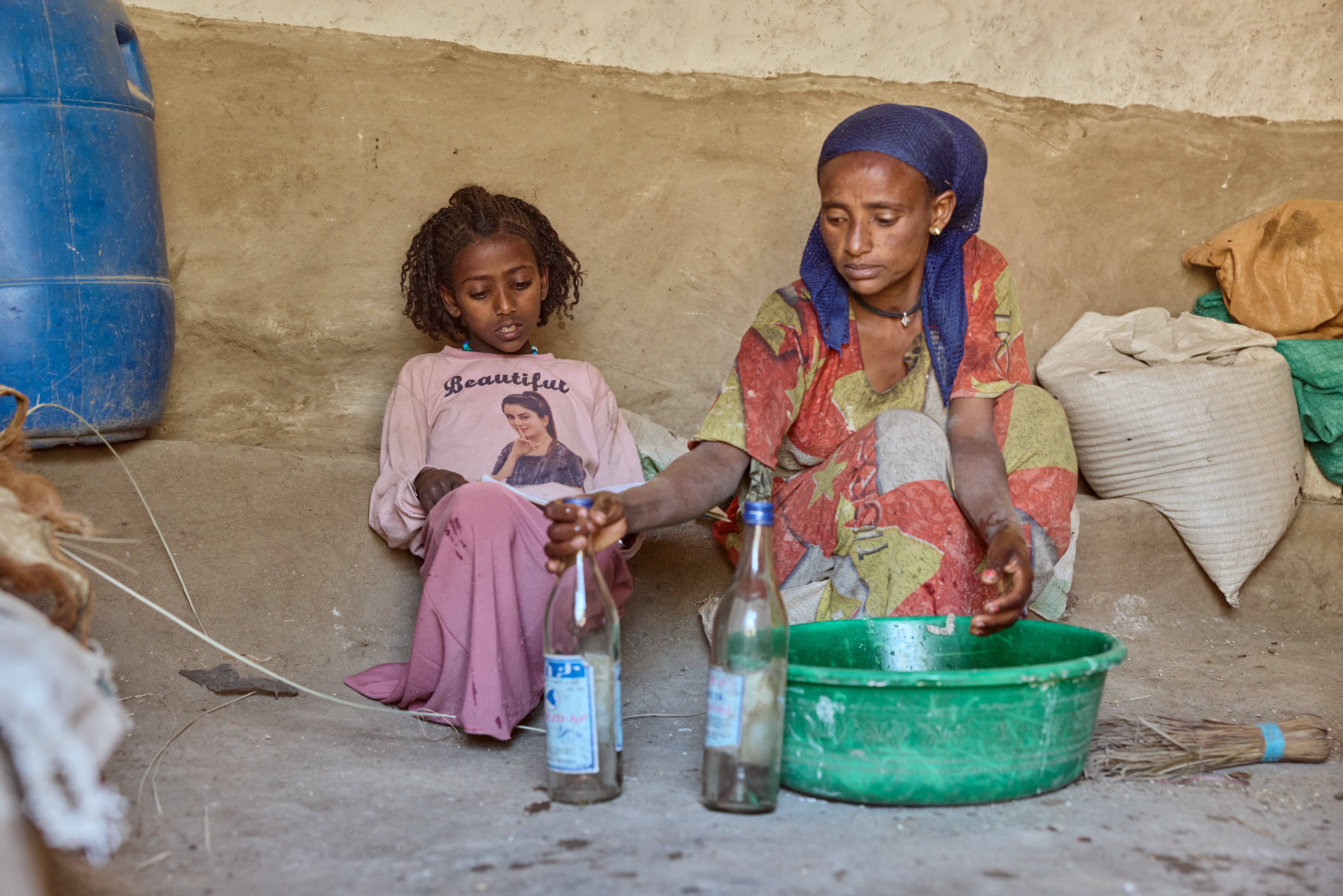 Aradech with her mother, Fitsum. Once a high-performing student, Aradech now struggles to stay alert during the day because of hunger and her grades are suffering
