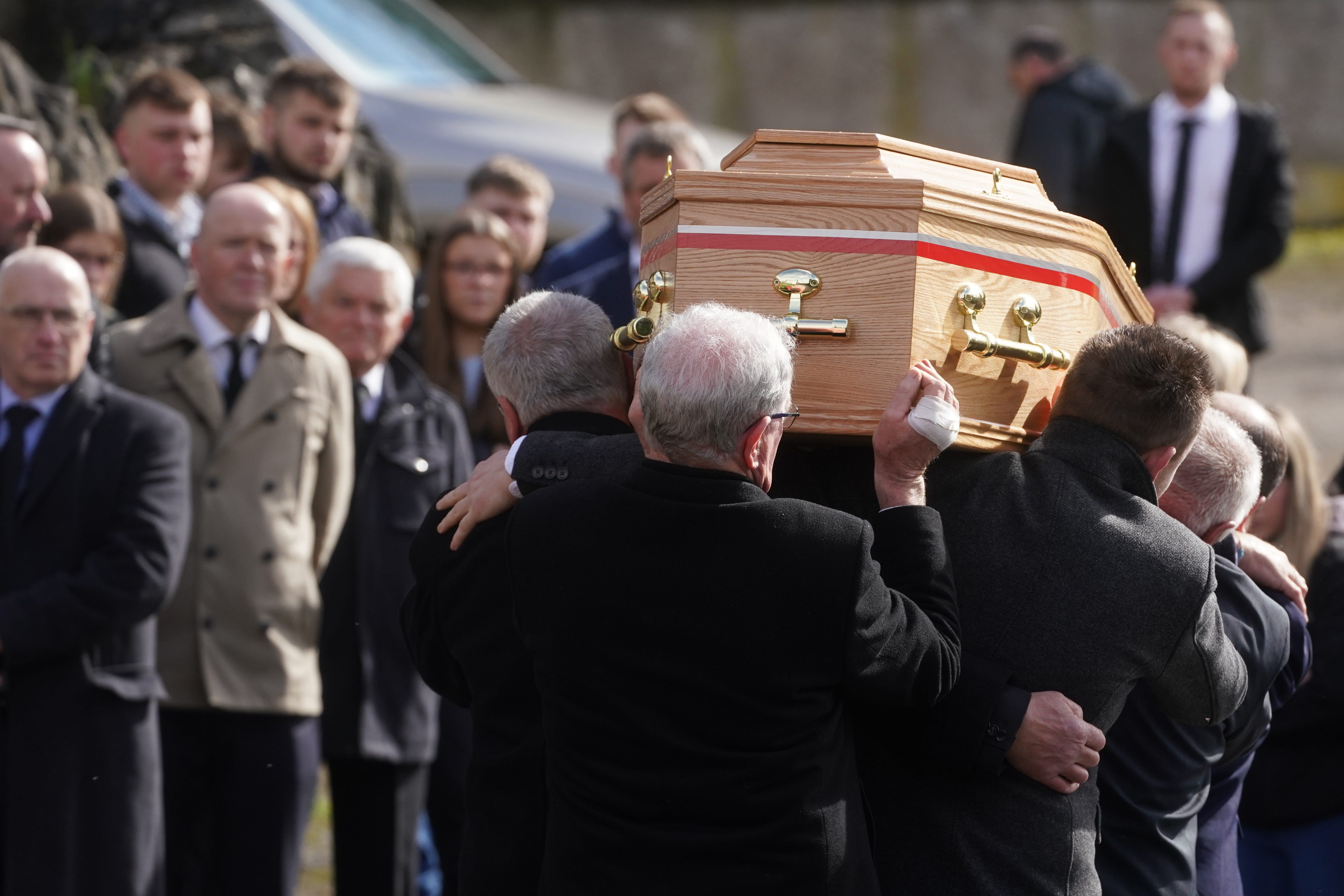 The coffin of Keith Morrison is taken from the back of a truck as it arrives for his funeral at Lislooney Presbyterian Church (Brian Lawless/PA)