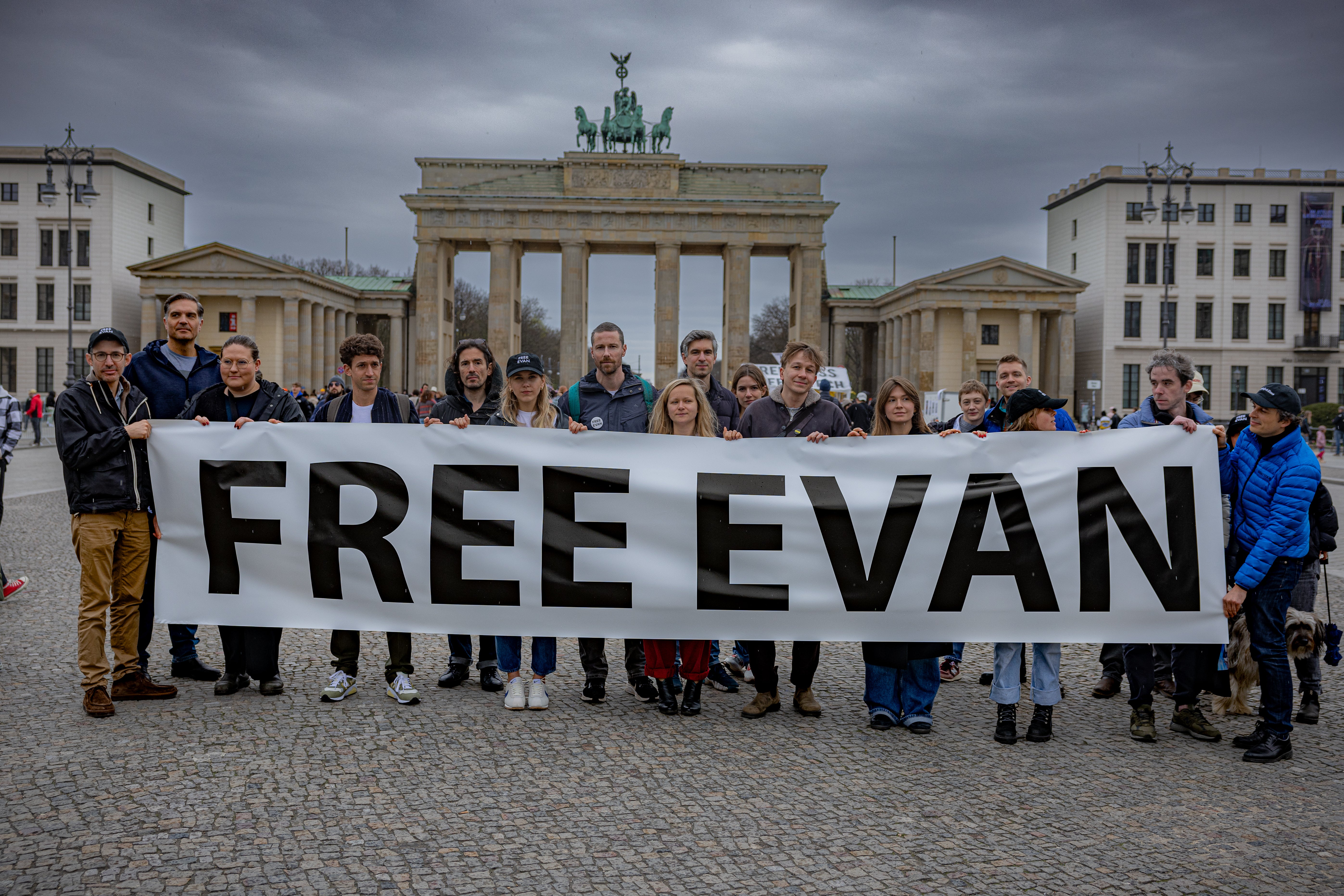 Supporters of Evan Gershkovich gather at Berlin’s Brandenburg gate, near the Russian Embassy to call for his release