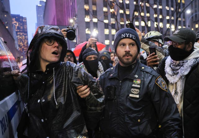 <p>A NYPD officer detains a protester during a demonstration calling for ceasefire in Gaza, near Radio City Music Hall in Manhattan, on the day of a fundraising event with U.S. President Joe Biden and former U.S. Presidents Barack Obama and Bill Clinton, amid the ongoing conflict between Israel and the Palestinian Islamist group Hamas, in New York City, U.S., March 28, 2024</p>