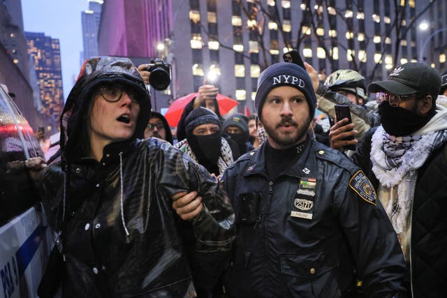 <p>A NYPD officer detains a protester during a demonstration calling for ceasefire in Gaza, near Radio City Music Hall in Manhattan, on the day of a fundraising event with U.S. President Joe Biden and former U.S. Presidents Barack Obama and Bill Clinton, amid the ongoing conflict between Israel and the Palestinian Islamist group Hamas, in New York City, U.S., March 28, 2024</p>