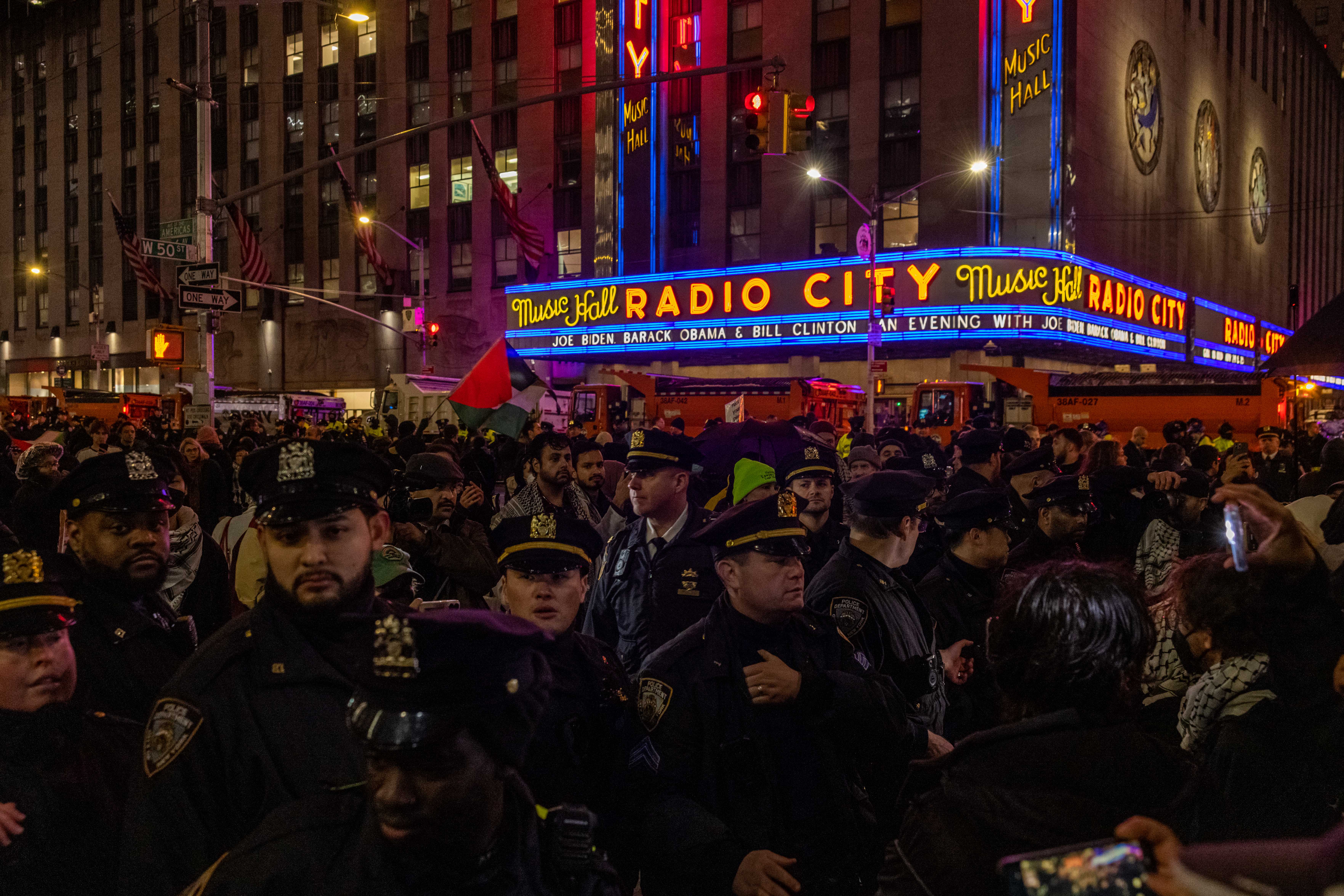 NYPD officers block pro-Palestinian demonstrators outside Radio City Music Hall during the fundraiser