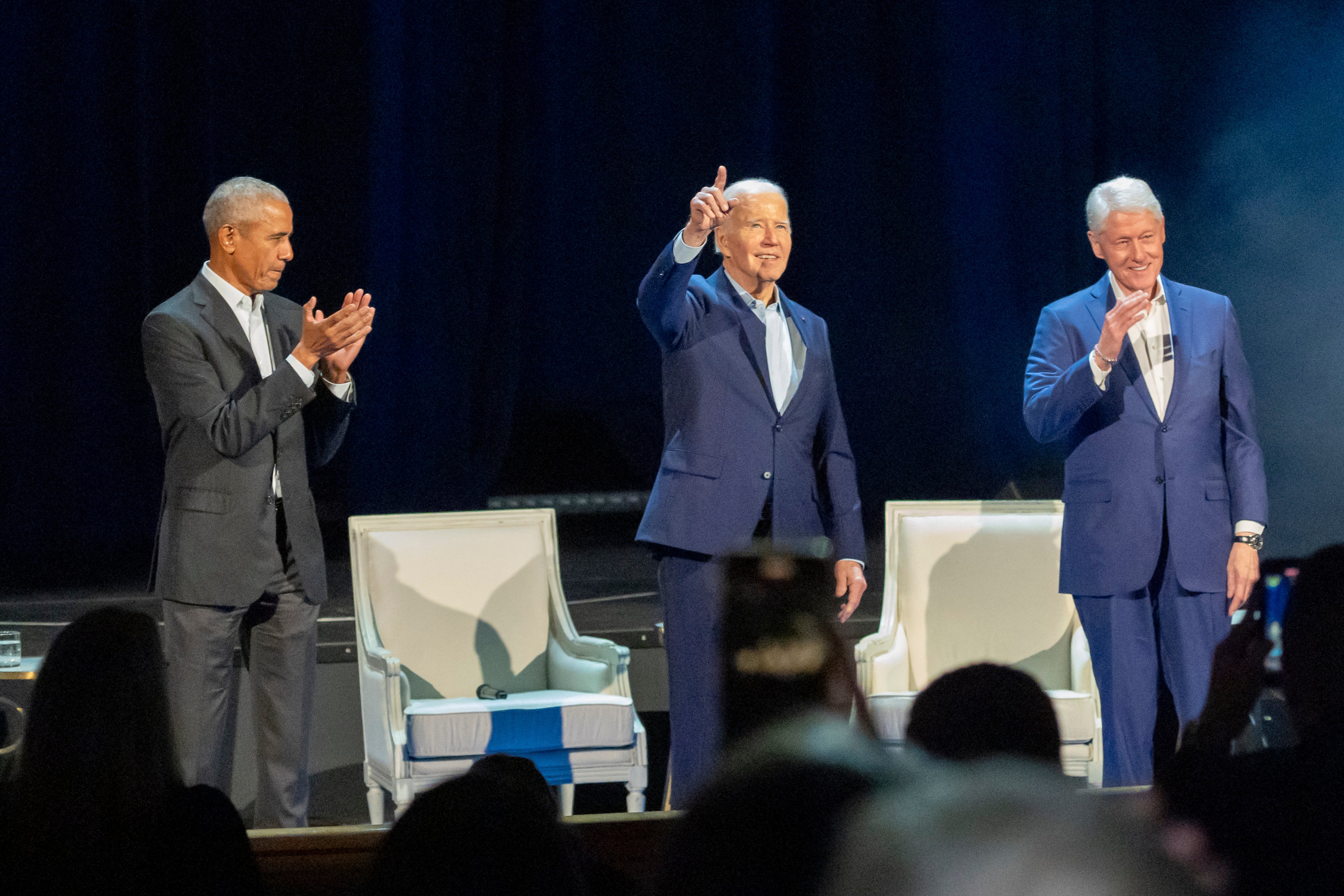 Barack Obama, left, Joe Biden, centre, and Bill Clinton at Radio City Music Hall on Thursday night