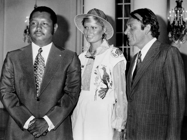 <p>Richard Burton (right) poses with his wife, Suzy Miller, and the president of Haiti, Jean-Claude Duvalier, in 1976</p>