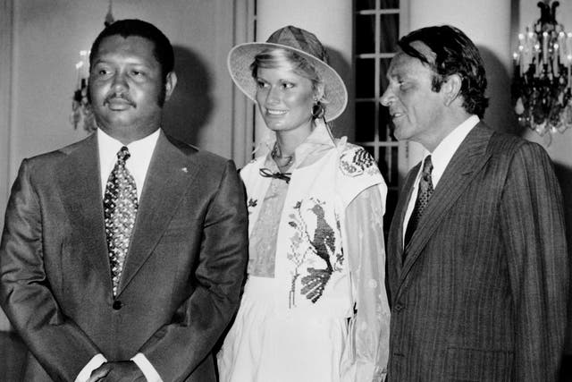 <p>Richard Burton (right) poses with his wife, Suzy Miller, and the president of Haiti, Jean-Claude Duvalier, in 1976</p>