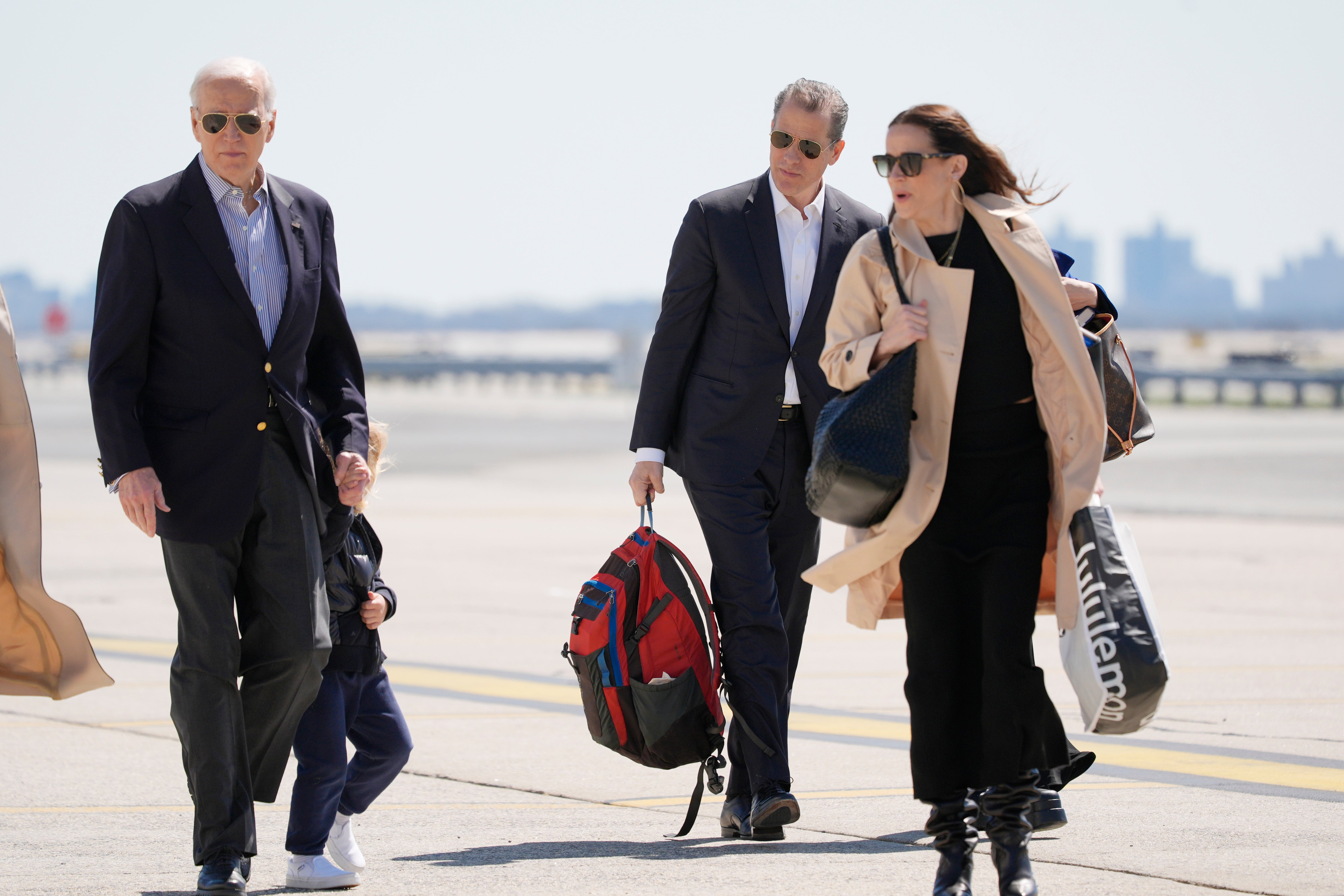 President Joe Biden walks with son Hunter Biden and daughter Ashley Biden as they walk to board Air Force One