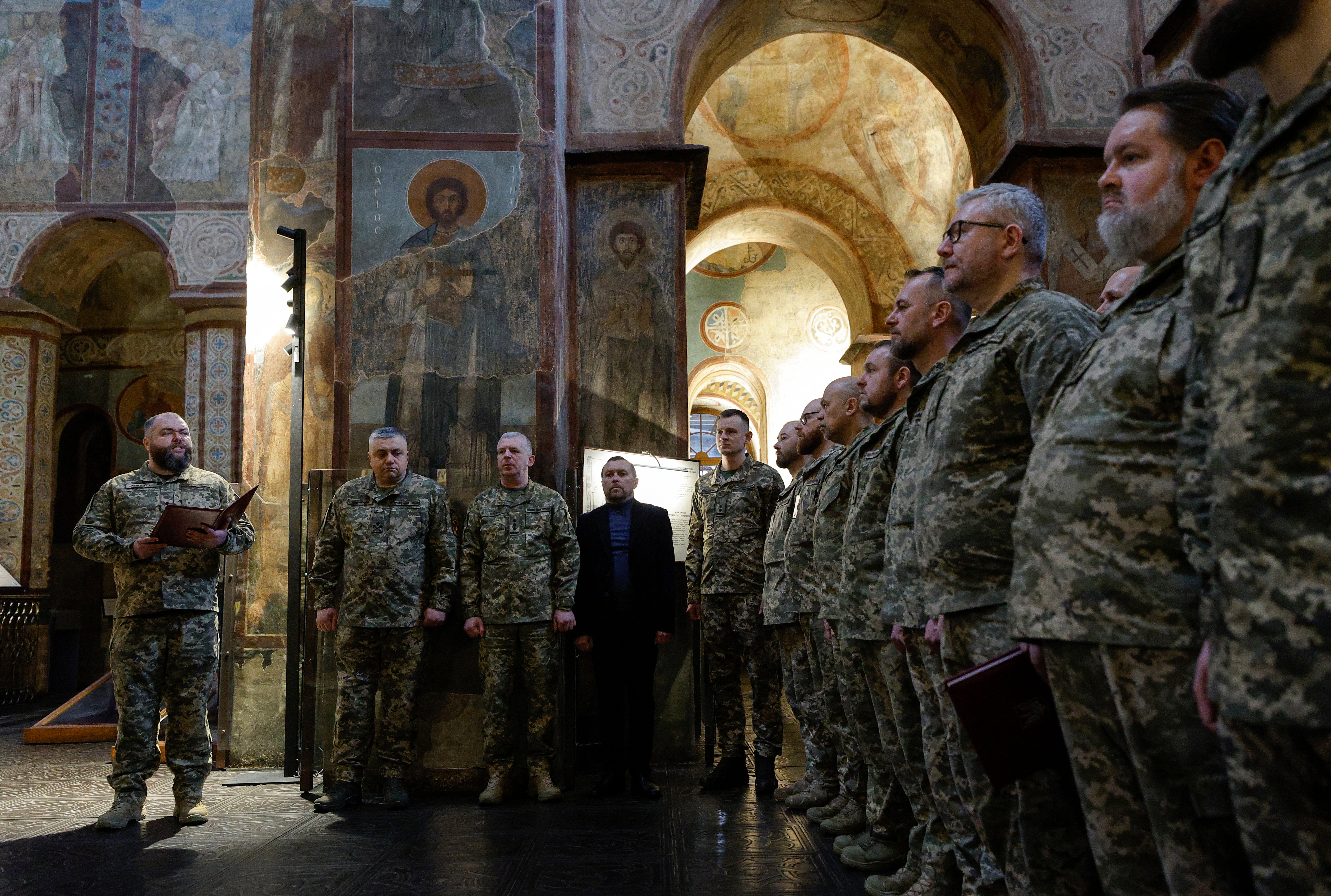 Ukrainian army chaplains attend a service during their graduation ceremony at St Sophia Cathedral in Kyiv on Friday