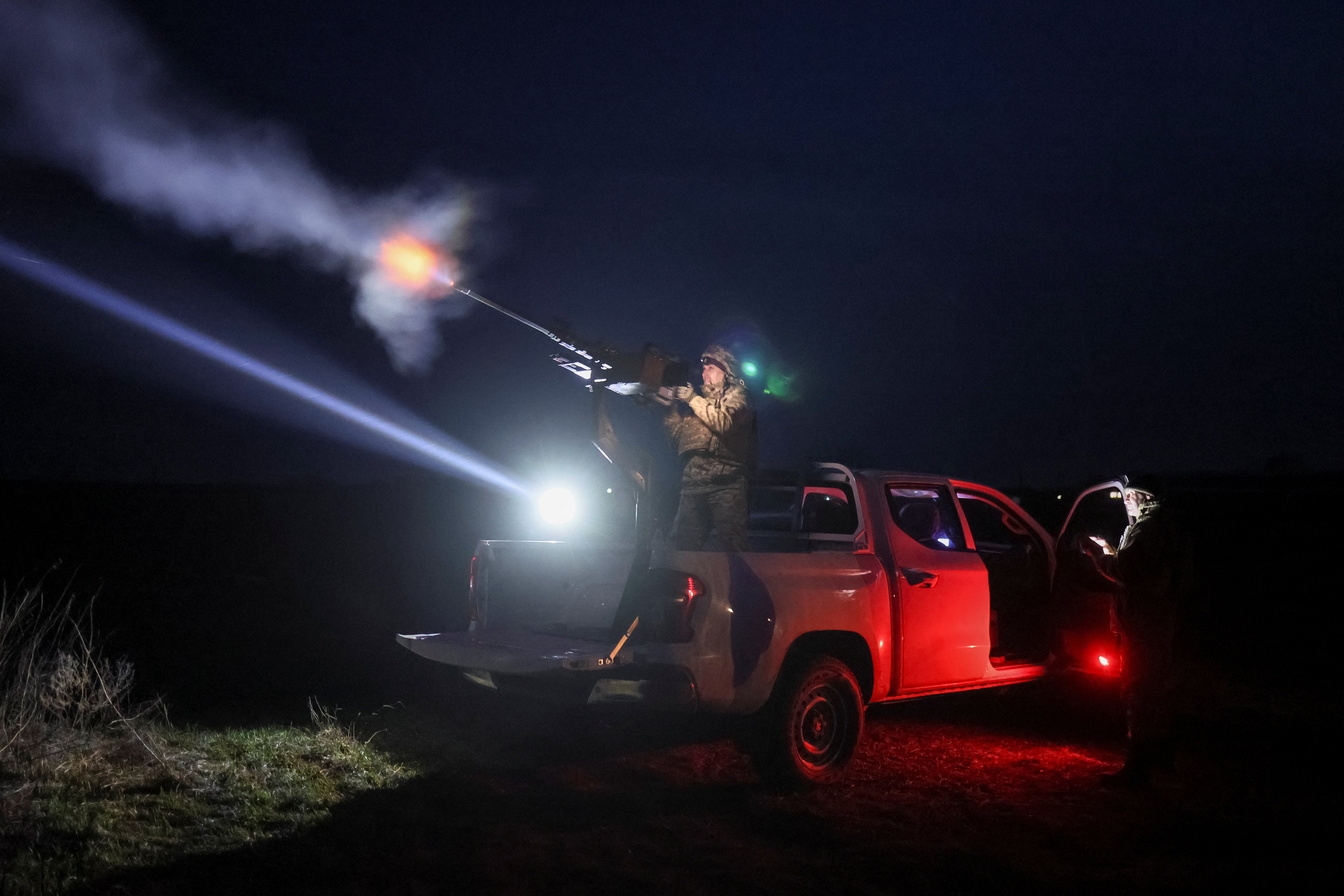 A Ukrainian serviceman from anti-drone mobile air defence unit fires a machine gun