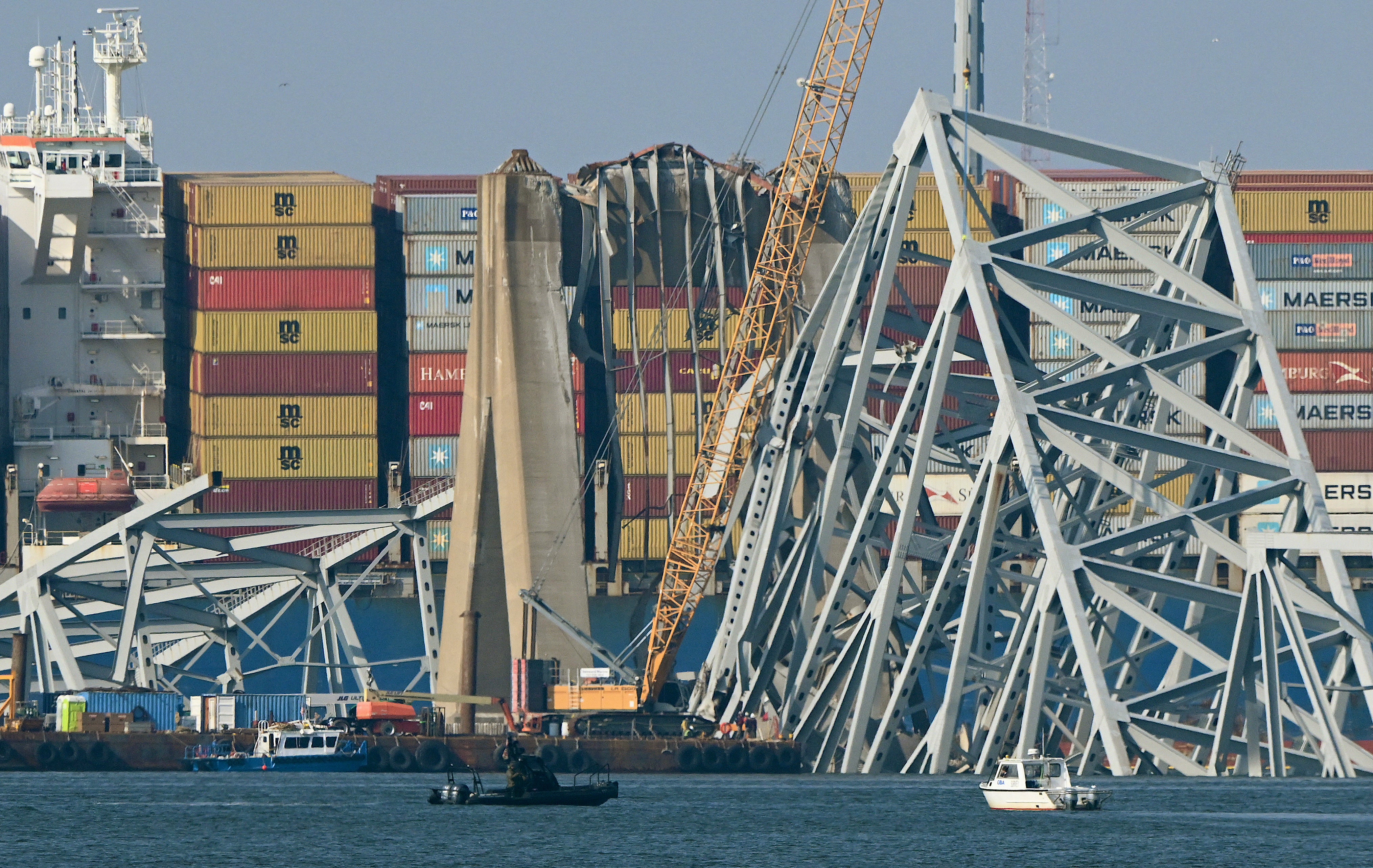 <p>A crane begins clean-up at the collapsed Francis Scott Key Bridge </p>