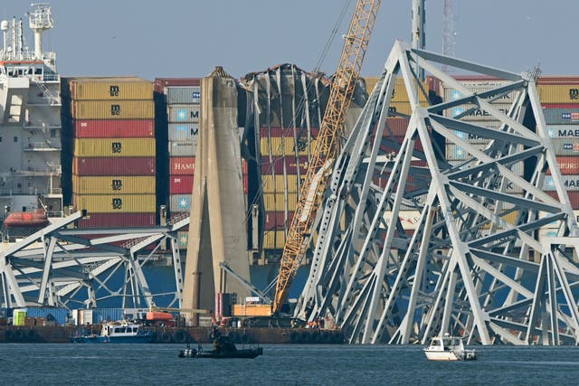 <p>A crane begins clean-up at the collapsed Francis Scott Key Bridge </p>
