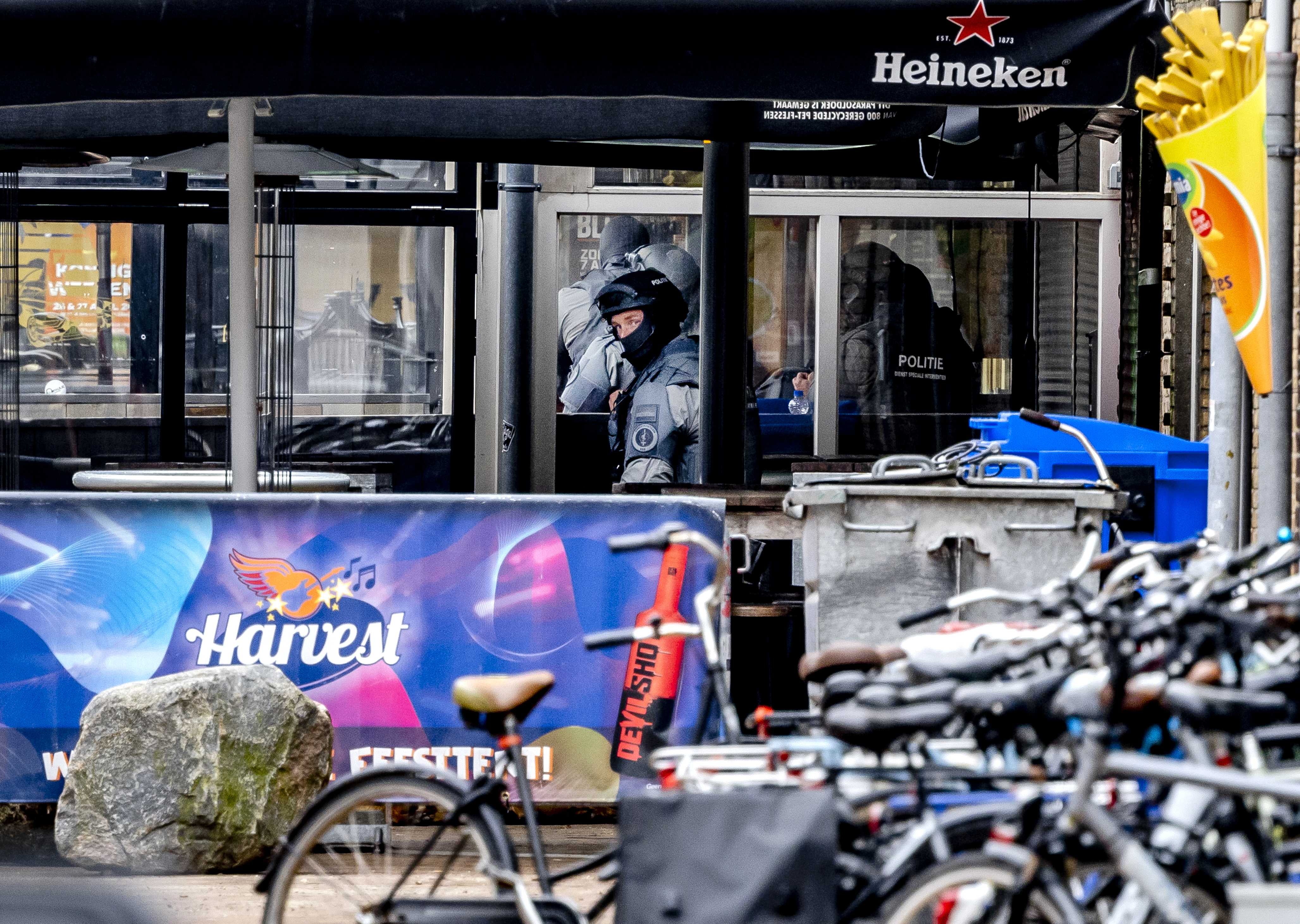 A member of a special unit of the police looks outside the Cafe Petticoat nightclub