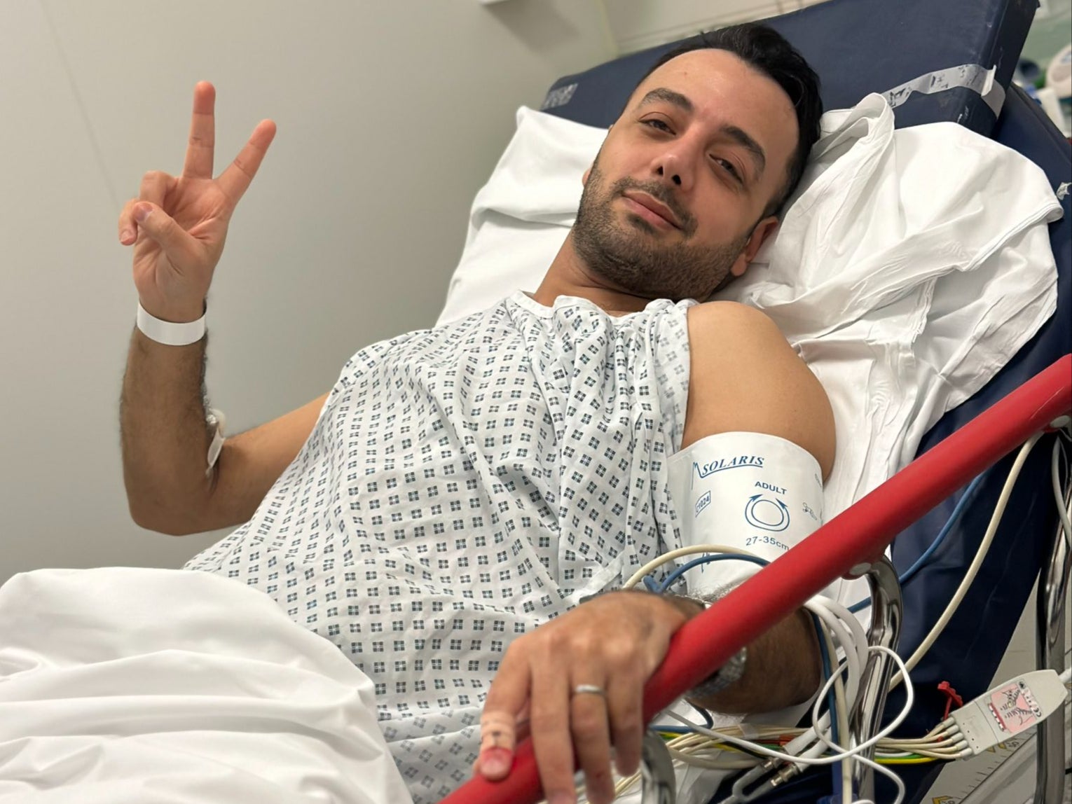 Pouria Zeraati released a defiant hospital picture after being stabbed on Friday