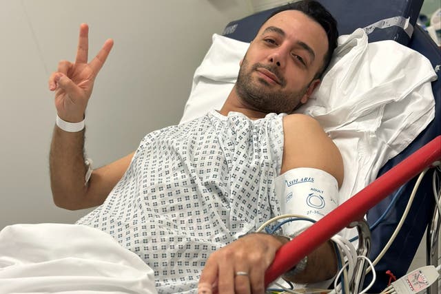<p>Pouria Zeraati released a defiant hospital picture after being stabbed on Friday </p>